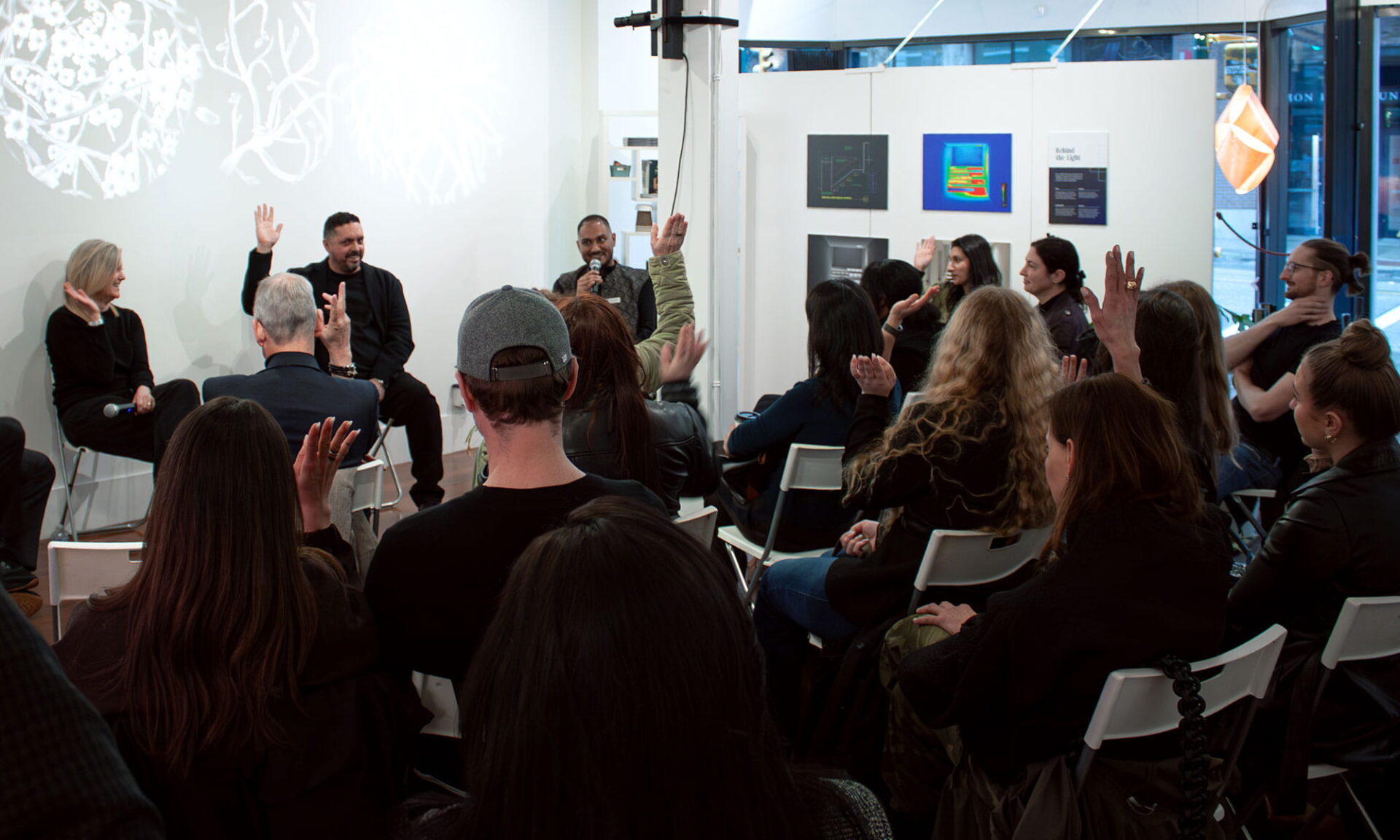 Audience attending a lighting design panel and listening to a discussion about coordination and late-stage changes.