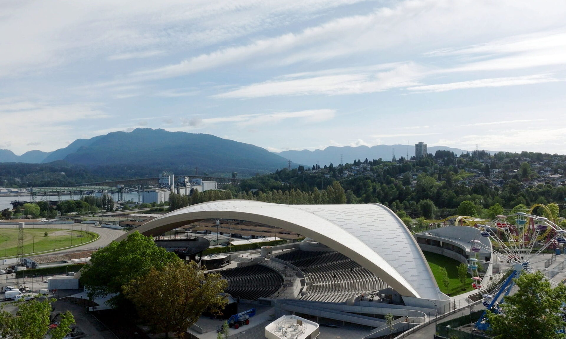 Wide daytime view of the PNE Amphitheatre Freedom Mobile Arch, showing the mass timber roof structure.