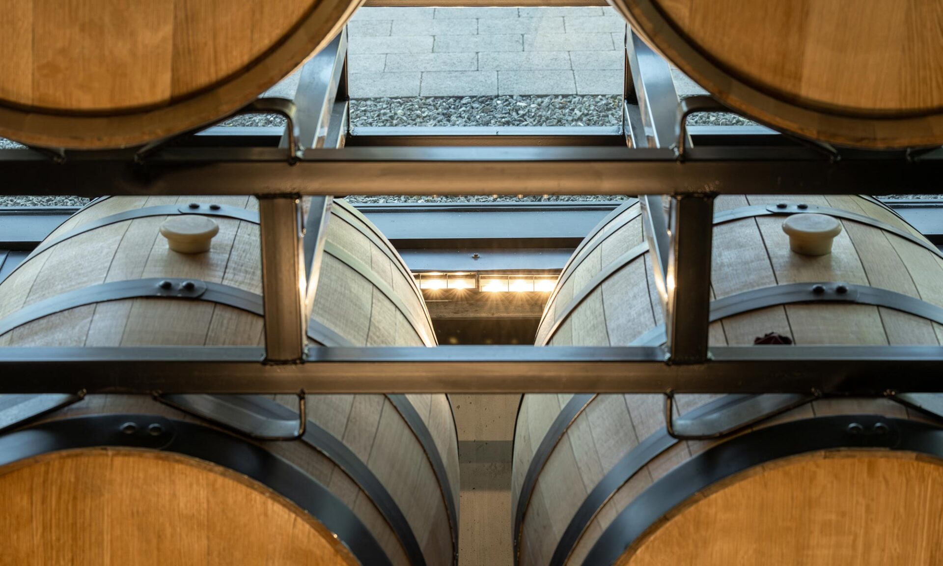 Close-up view of the barrel wall in Unsworth Vineyards’ main tasting room, showing the SSL CoveLine fixture integrated between barrels to wash the feature wall with light.