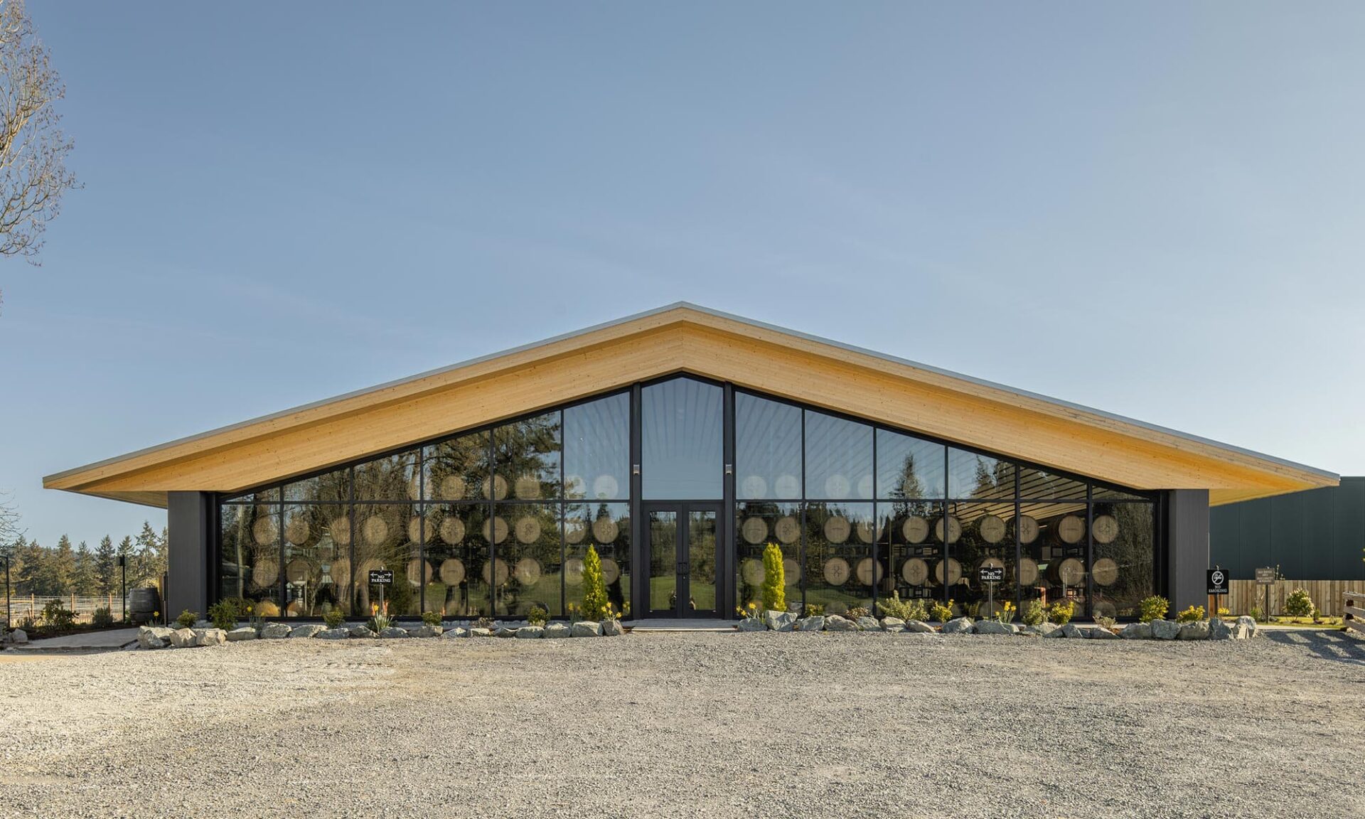 Exterior view of Unsworth Vineyards’ new tasting room at night with interior lights off, showing the building’s form with minimal illumination.